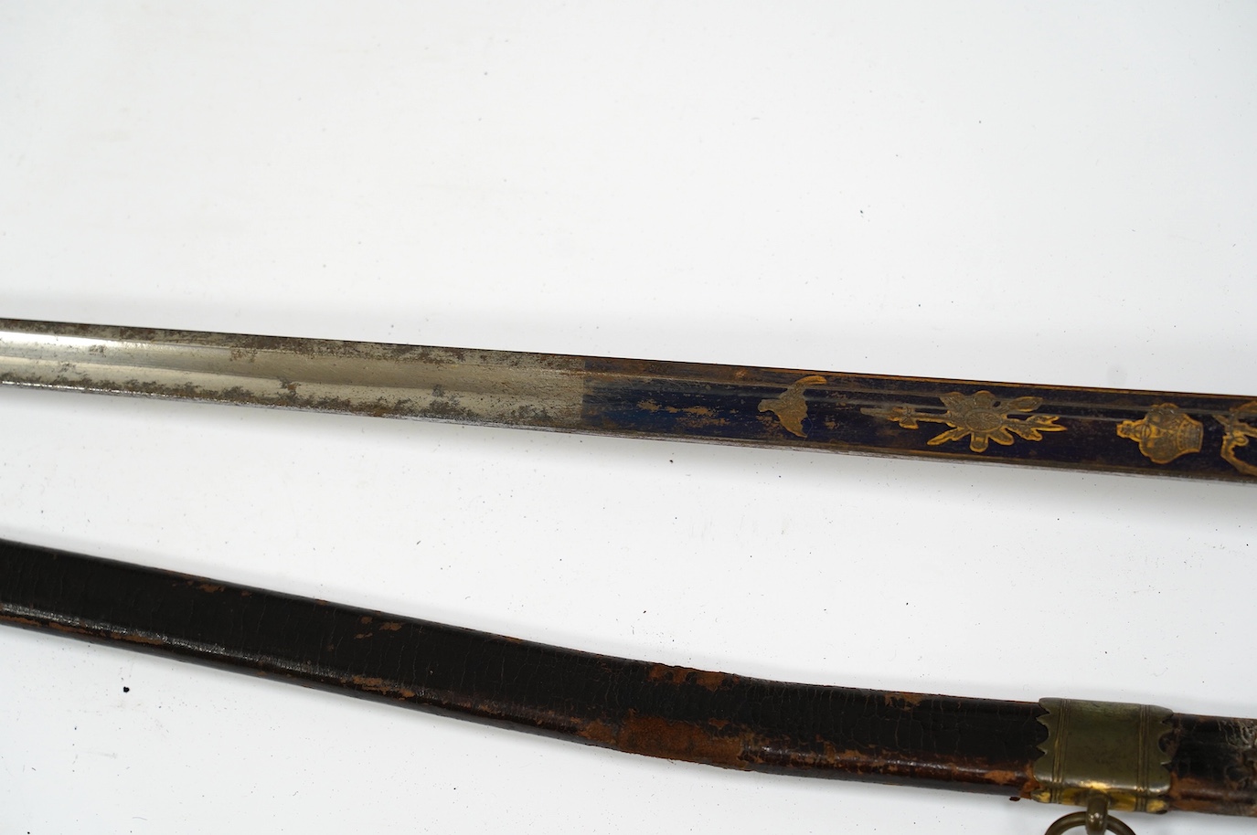 A 1796 pattern infantry officer's sword, blued and gilt blade, etched with crowned GR and Royal Arms, regulation gilt brass hilt, in its leather scabbard with brass mounts, locket signed S. Brunn, 81.5cm. Condition - goo